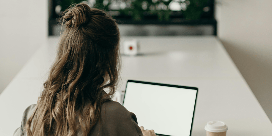 professional woman typing on a laptop