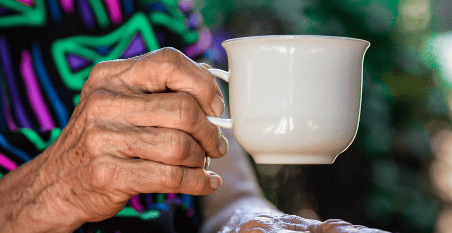 elderly woman holding a cup of tea