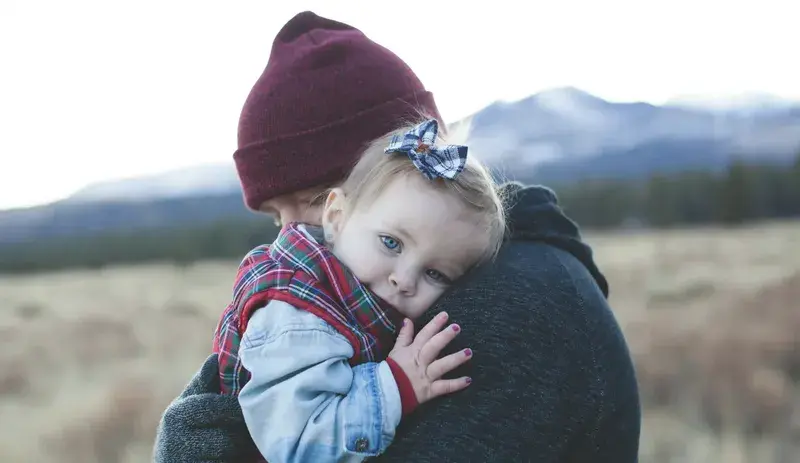 father hugging his little daughter