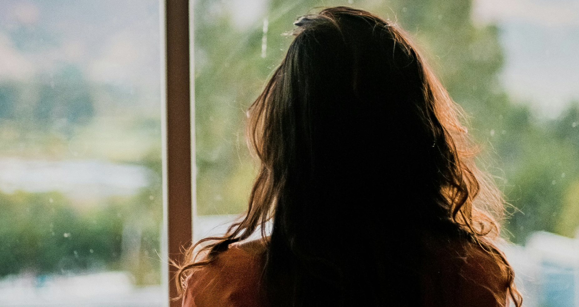 woman looking out the window