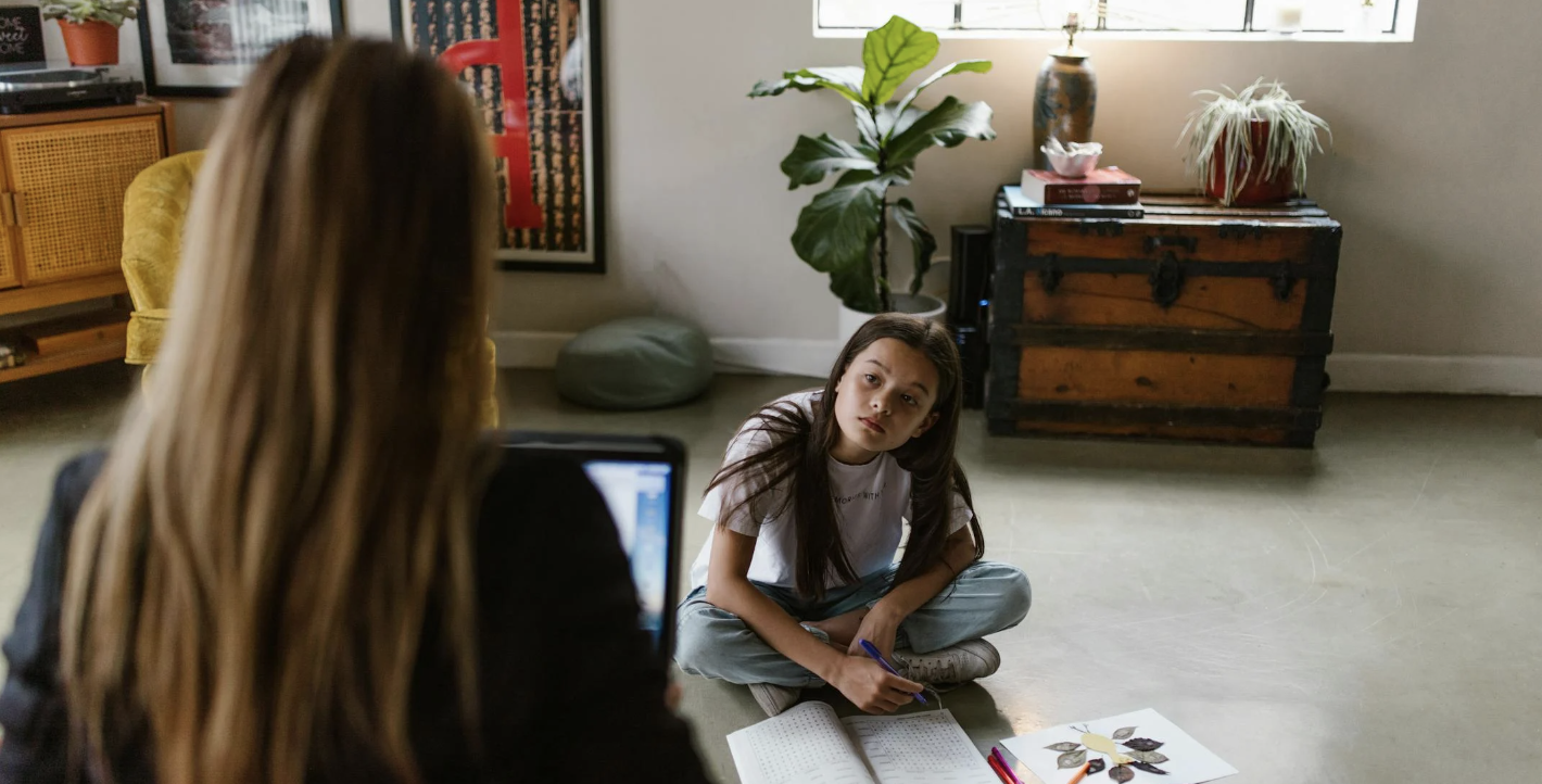 mom trying to work while her daughter needs help with homework