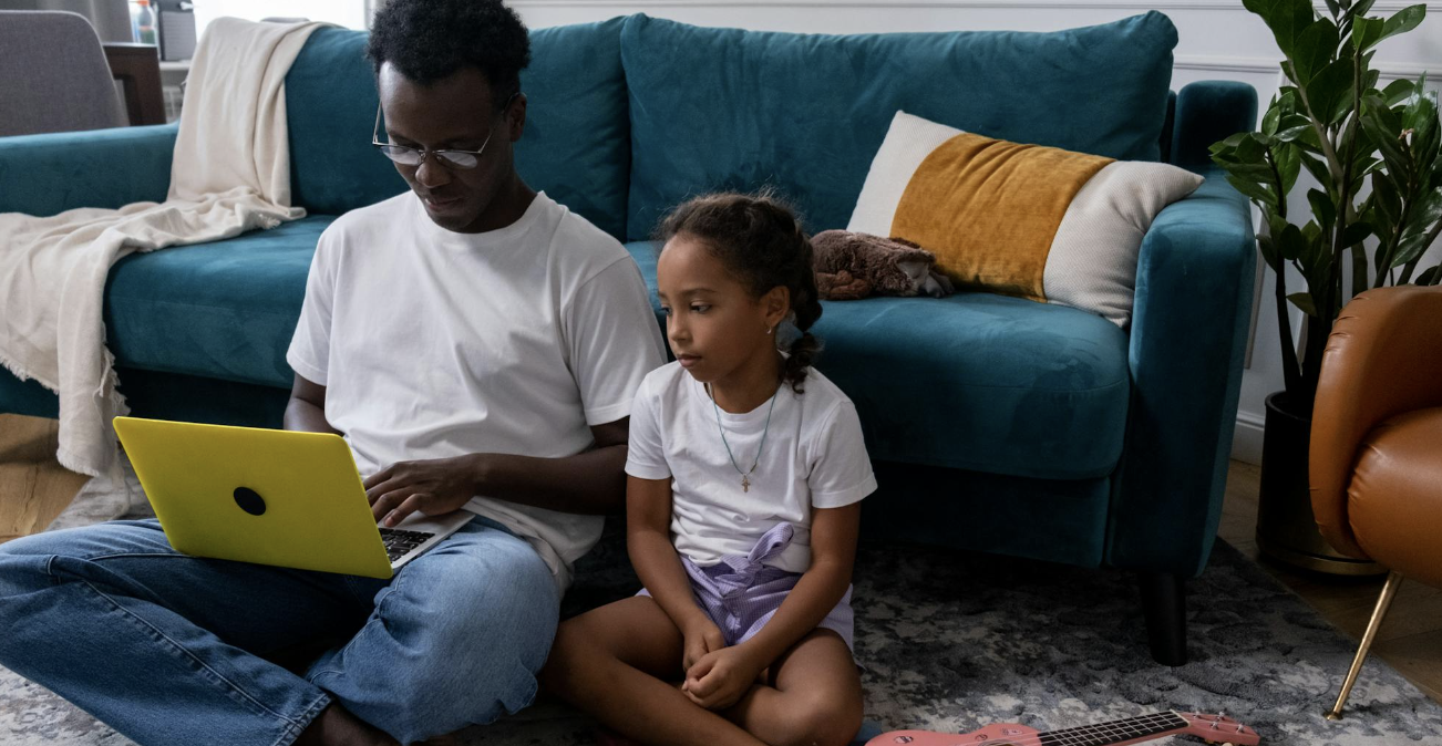 dad trying to work while his daughter watches 