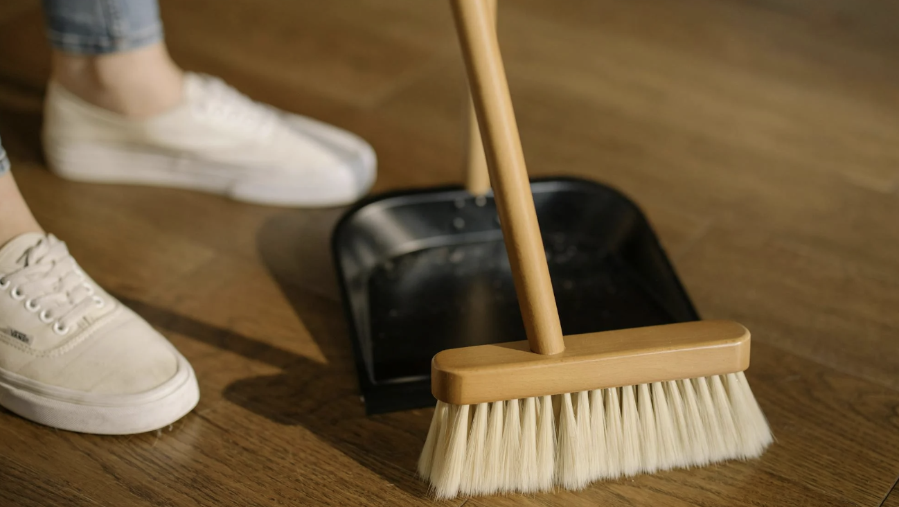 woman's shoes seen as she is sweeping the floor