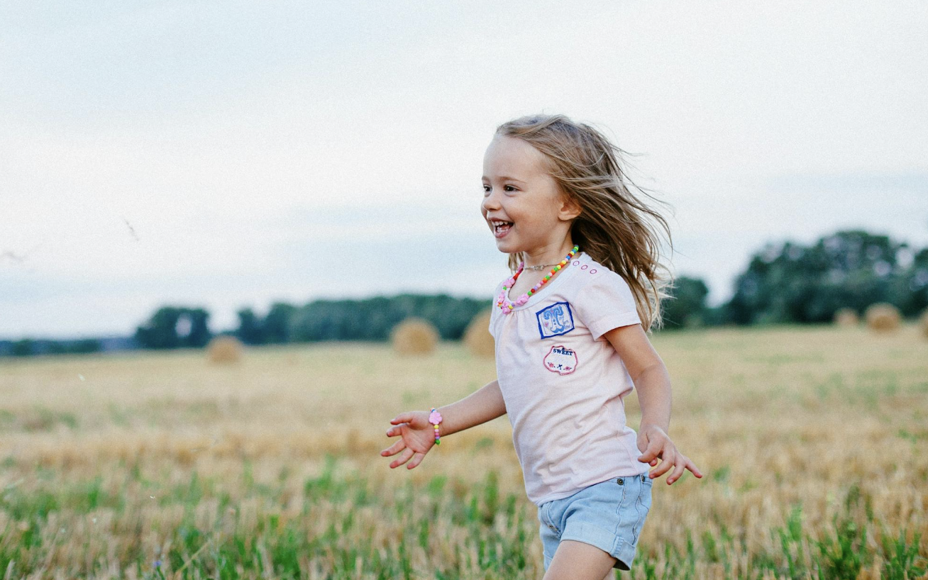 happy child running through a field