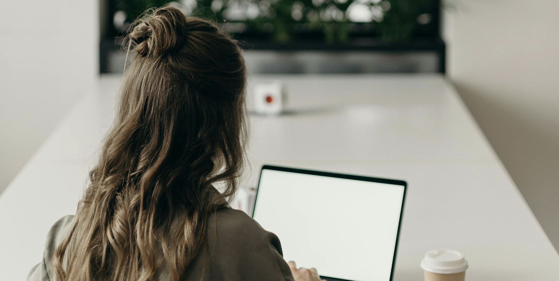 professional woman typing on a laptop