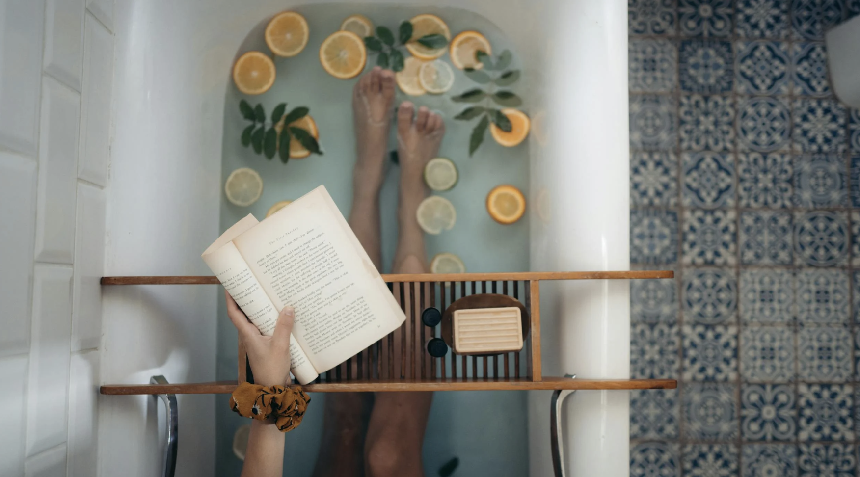 woman in the bathtub reading and practicing self-care