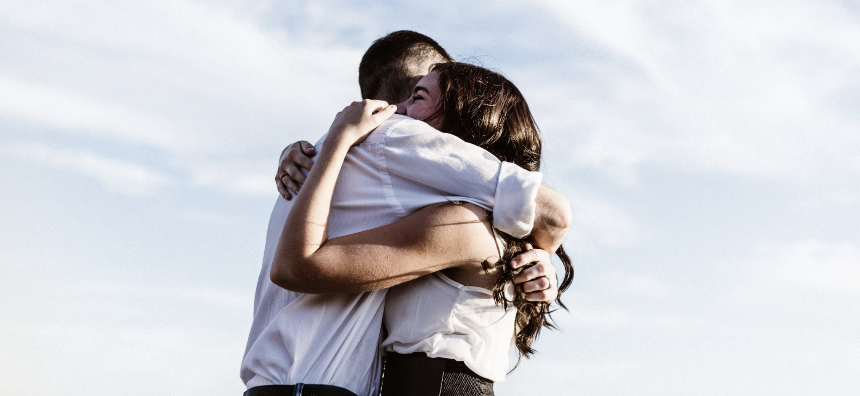 man and woman embracing and hugging in support of one another