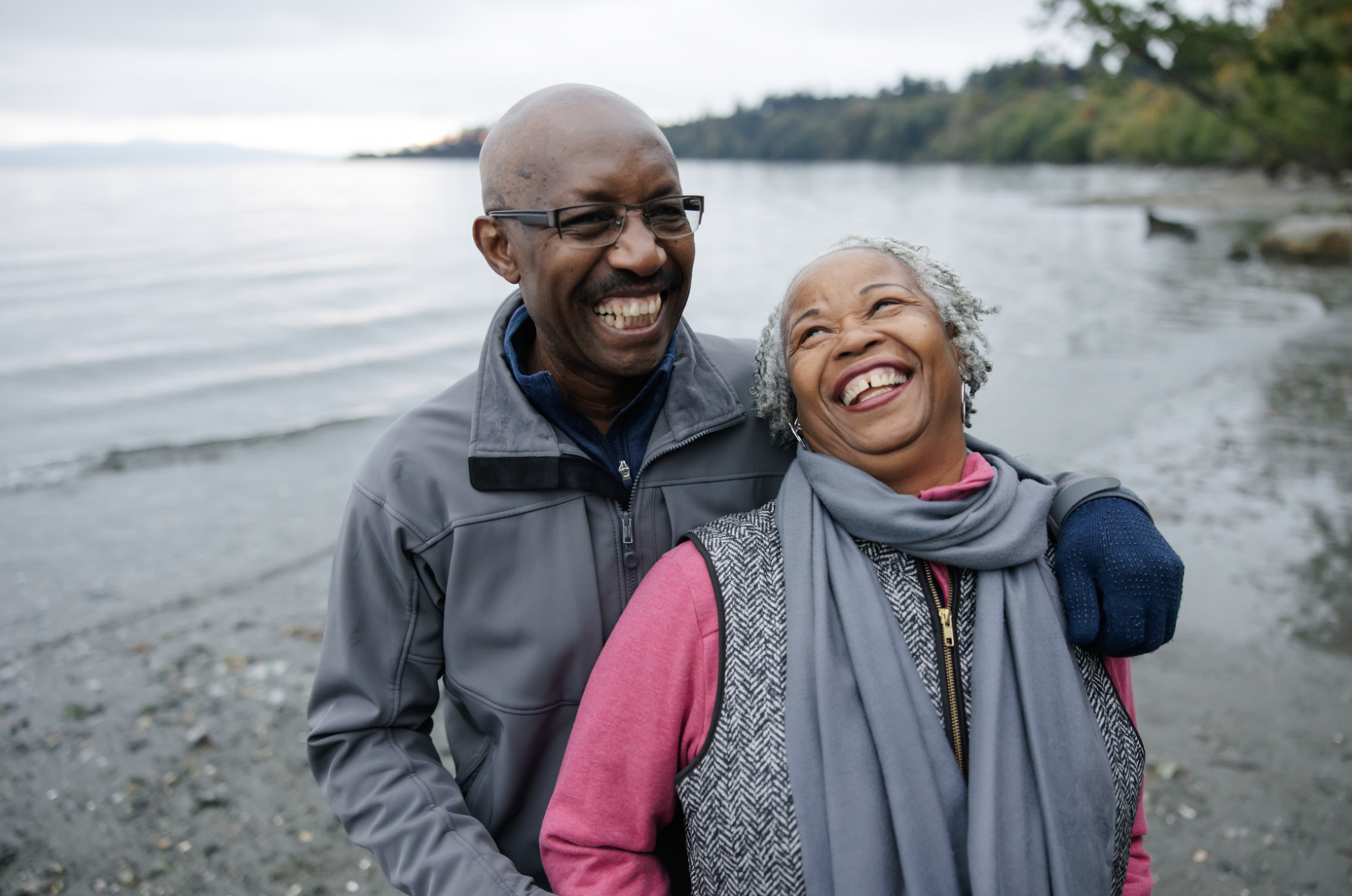 an older couple smiling by the water