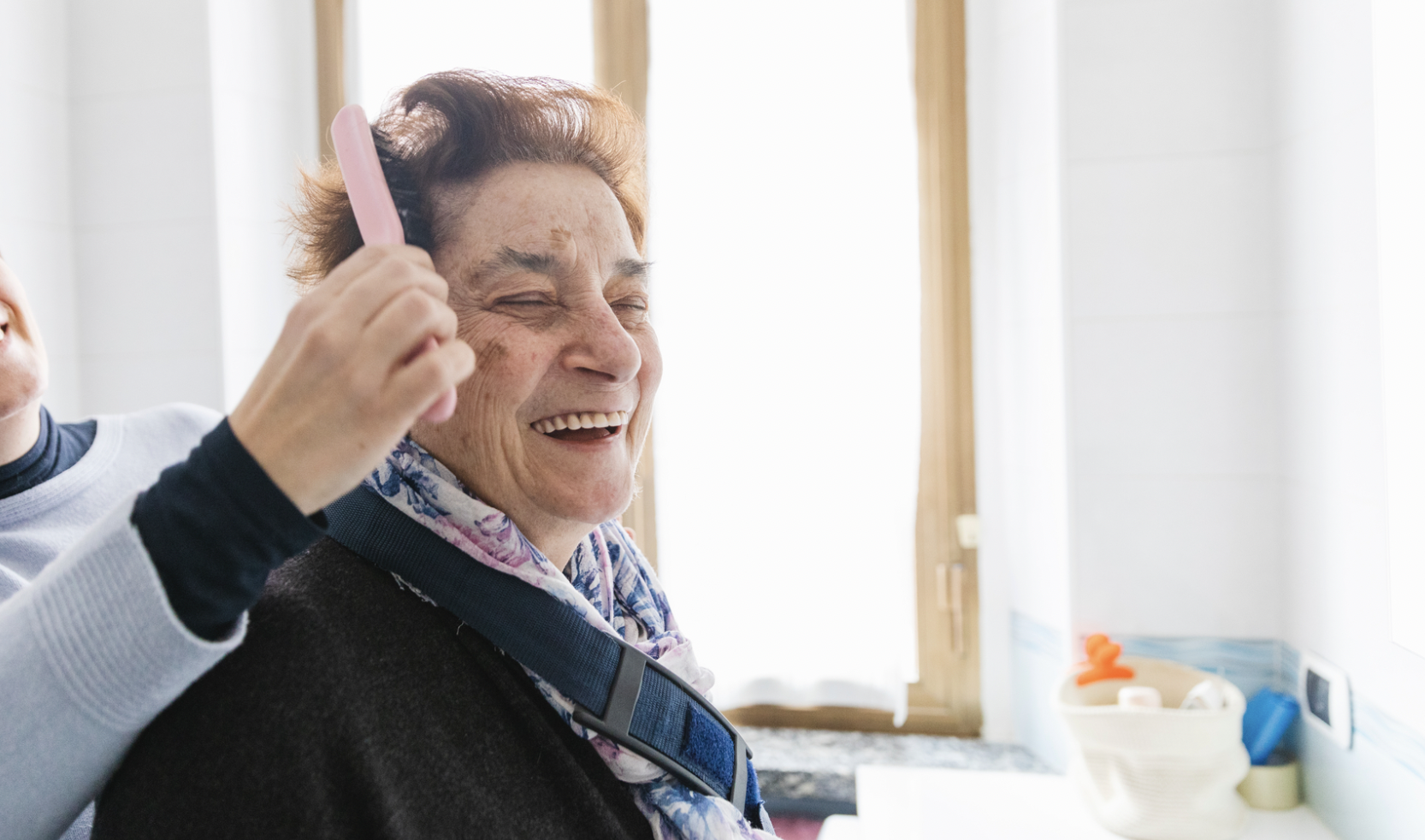 elder woman get her hair combed